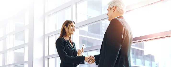Businesswoman shaking hands with a businessman, Dubai business start-up.